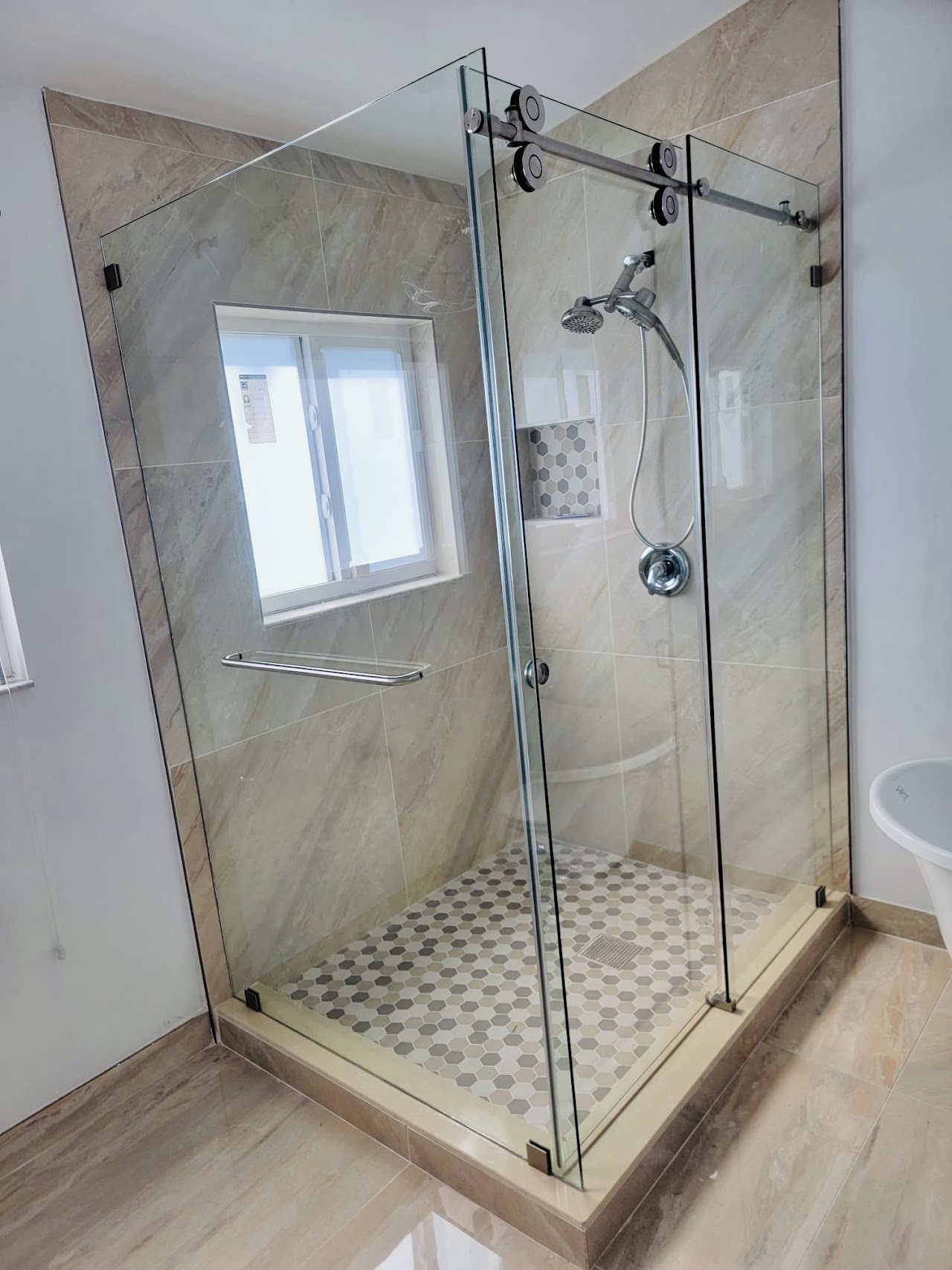 Custom glass shower enclosure with dark hardware