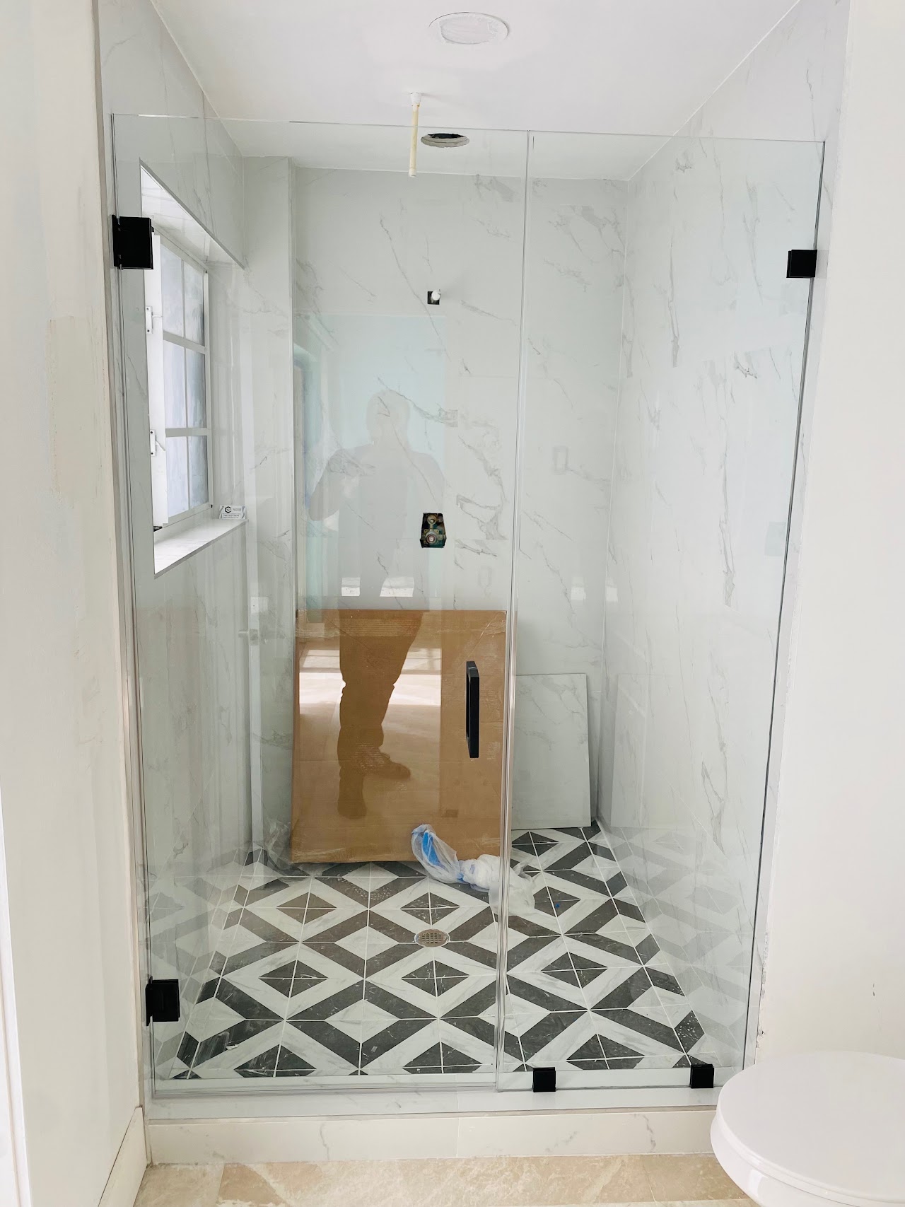 Clear shower door with patterned floor